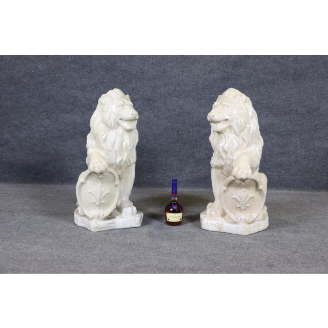 Standing with an unmistakable sense of grandeur and authority, this magnificent pair of monumental porcelain lions...