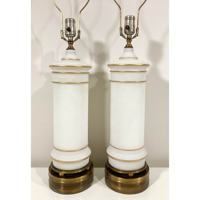These stately traditional style lamps are unmarked but likely American from the 1940s-1950s. The white frosted glass with...