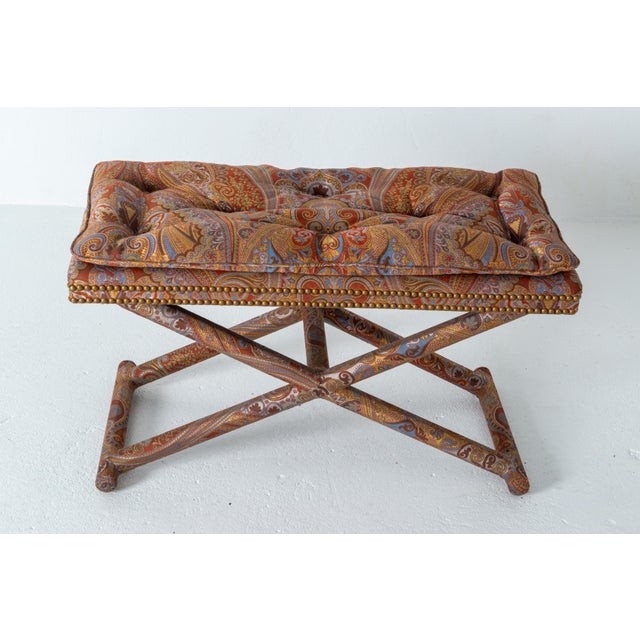 In the spirit of Billy Baldwin, an all paisley upholstered X form base rectangular bench. An attached knife edge buttoned...