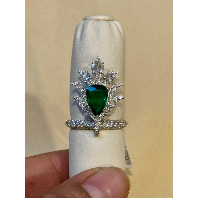 2 Ct Finest Zambian Pear Emerald & 2 Ct Diamond Ring in 18 Kt Gold Size 7. This classic ring features a pear-shaped...