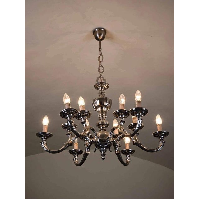 A radiant chandelier made of polished white brass. The chandelier is also suitable for a larger room. Six double arms. The...