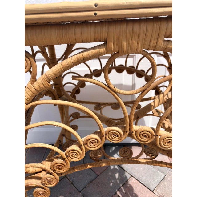 Coastal handcrafted wicker side table in a natural rattan color with beautiful filigree detail on all four sides and woven...