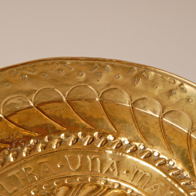 18th century large Alms dish of gold shiny brass depicting Lamb of God metaphor. In the center the Lamb of God set within...