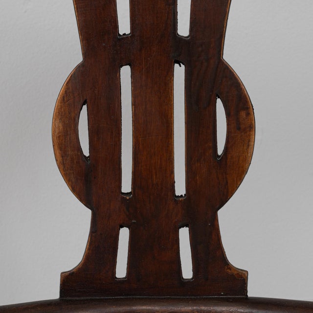 This 20th Century Austrian bentwood armchair with a lyre back detail beautifully showcases the fluid curves and...