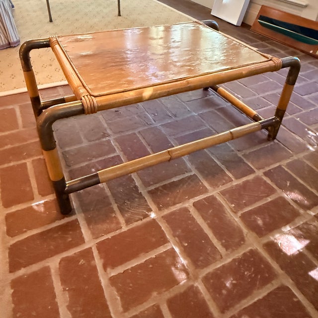 1970s Bamboo & Brass Coffee Table A cool and unique table with a bamboo frame and curved brass joiners. We’ve never seen...