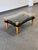 Fabulous Postmodern wavy glass top coffee table with glossy black lacquer lower level. Walnut toned ball detail and...