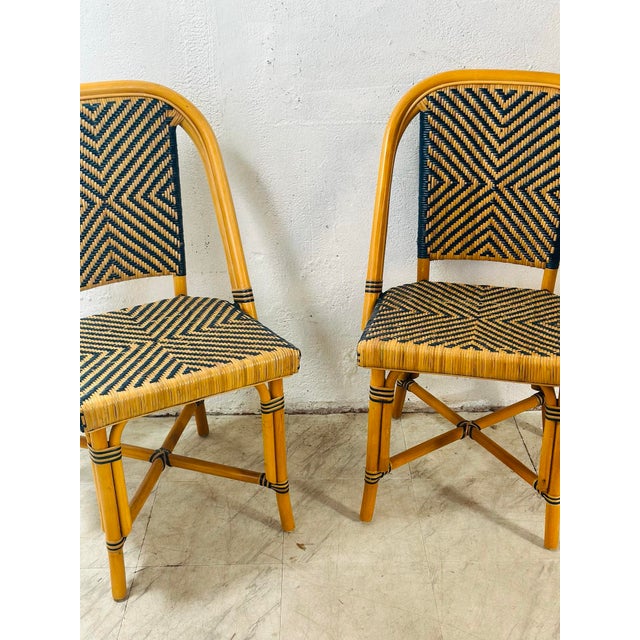 These are a charming pair of vintage rattan bistro-style chairs with a classic European café feel—very reminiscent of...