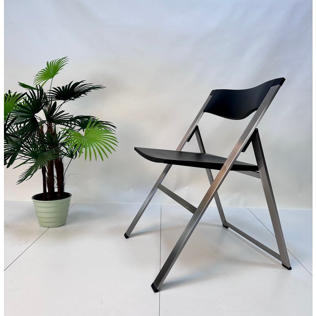 A pair of iconic p08 folding chairs, impressive examples of early 1990s minimalist design. During this time the award-...