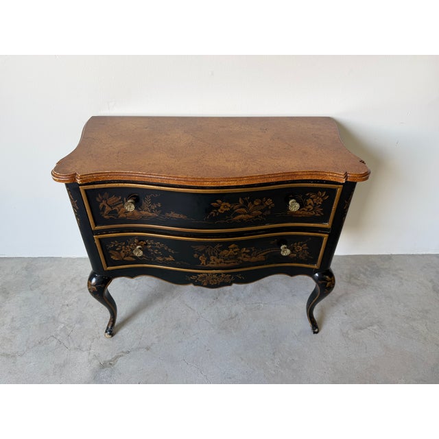 Beautiful vintage Drexel chinoiserie nightstand featuring a black finish with detailed gold Asian landscape scenes...