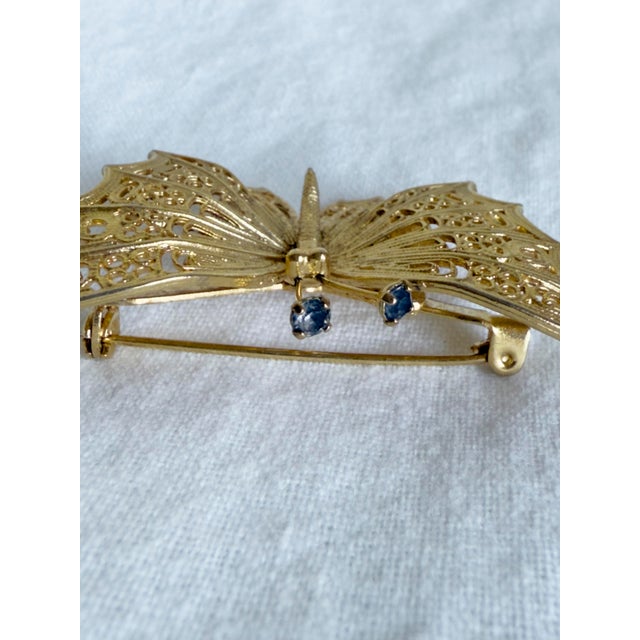 Monet Vintage 1960s Art Nouveau Revival Gold Tone Filigree Butterfly Brooch With Blue Rhinestone Accents For Sale - Image 4 of 7