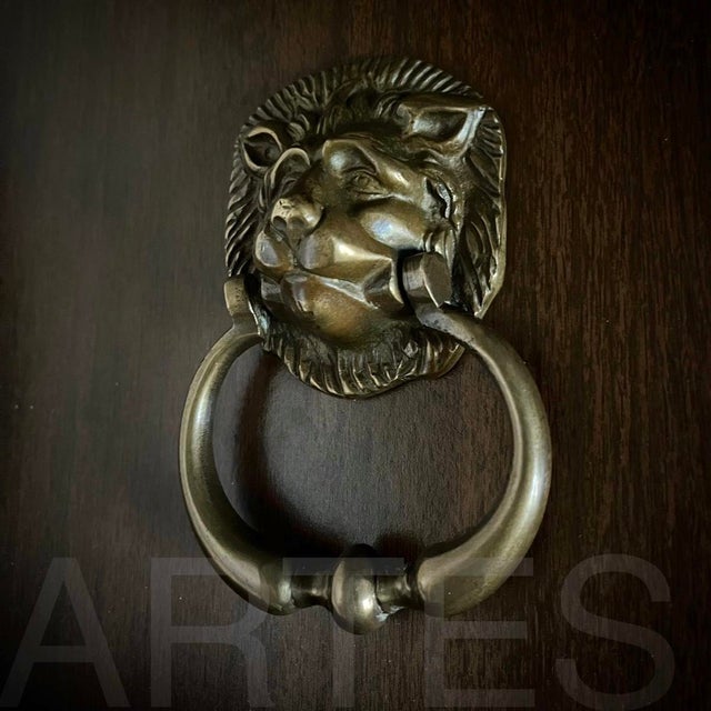 An impressive lion's head door knocker on a large door always makes for a grand entrance. This beautiful cast brass...