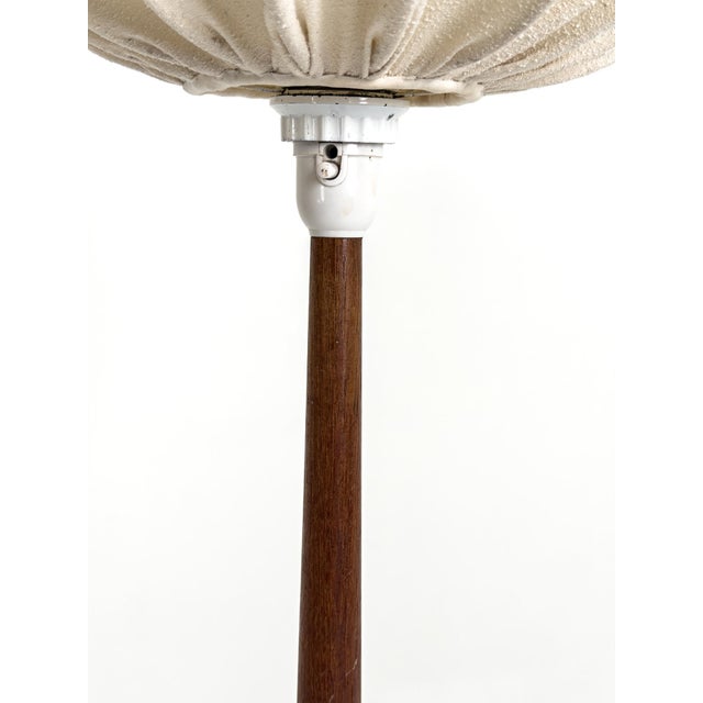 Scandinavian Modern tripod floor lamp produced in Sweden during the 1960s. The lamp features a finely crafted teak tripod...
