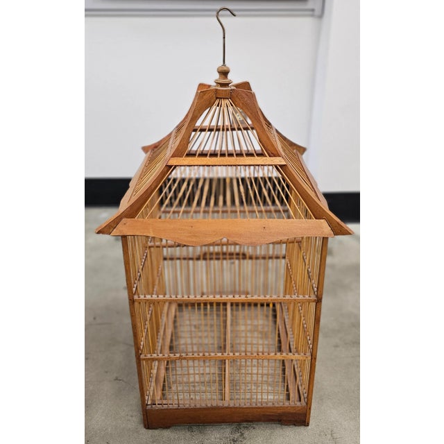 Mid Century Chinese Style Teak Bird Cage Measures 18" in width x 18" in depth x 34" in height.