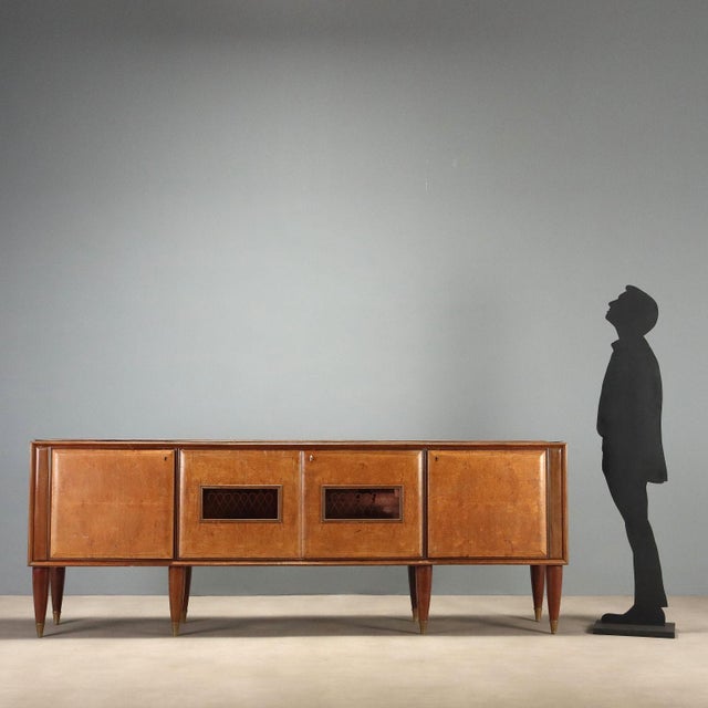 1950s buffet cabinet featuring four hinged doors, with the central two adorned with elegant pink-tinted glass with...