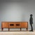 1950s buffet cabinet featuring four hinged doors, with the central two adorned with elegant pink-tinted glass with...