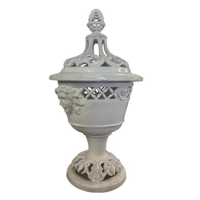 A monumental and architectural Mid-Century Italian white glazed ceramic covered urn, masterfully crafted to bring...