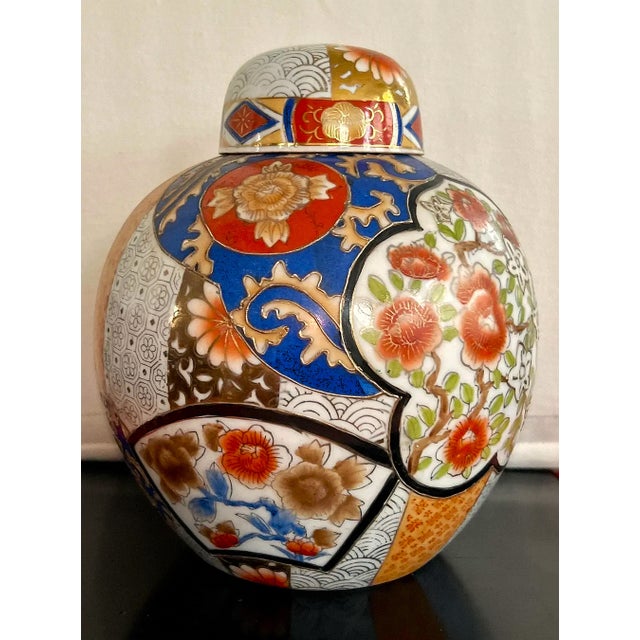 Beautiful vintage ginger jar. Hand painted with detailed orange and gold flowers on a blue and white background. No chips...