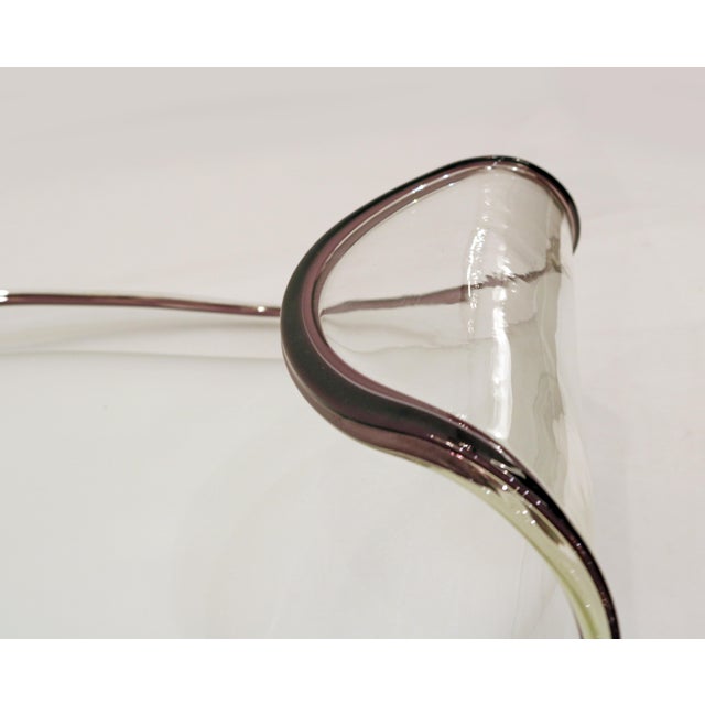 Pair of shallow glass dishes made of tricoloured Murano glass in an oval shape with a slightly curled end. The center...