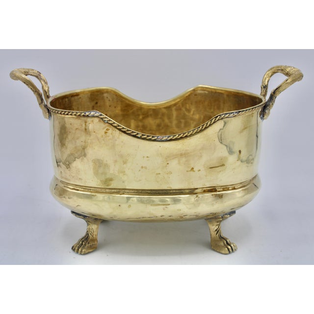 A gorgeous brass cachepot planter with lion’s feet and handles, made in Spain, circa 1950s. This is a stunning mid-20th...