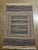 Handwoven Persian kilim flatweave rug featuring a structured composition with a central panel of horizontal stripes...