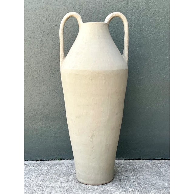 Influenced by ancient Mediterranean vessel forms and striking architectural scale, this 41-inch tall vintage floor vase...