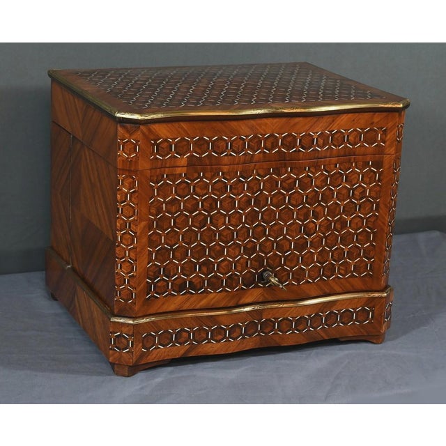 Beautiful liqueur cellar in wood marquetry forming hexagons. The eventful facade is accompanied by cut sides on the sides....