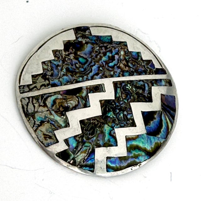 A beautiful, vintage Taxco Mexico sterling silver pendant/brooch, inlaid with abalone and featuring a geometric design in...