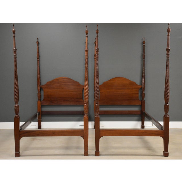 A pair of antique twin sized beautifully turned four poster bed made of solid mahogany. Made in USA. Circa 1920’s....