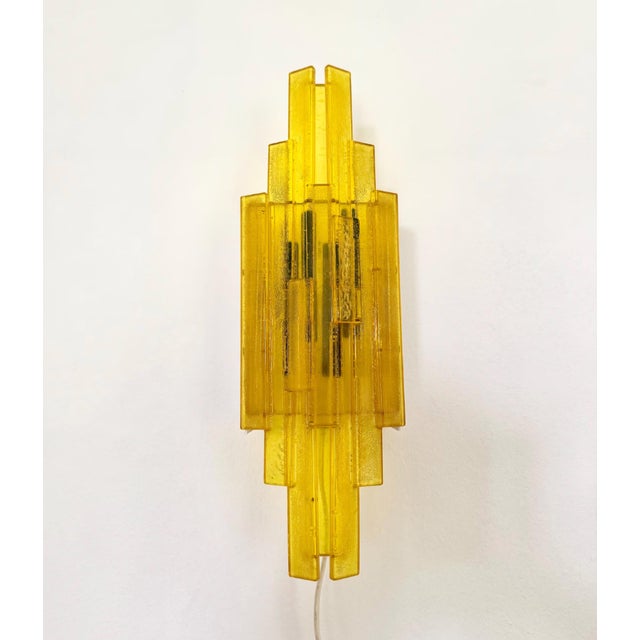 Pair of iconic acrylic wall lamps designed by Claus Bolby, produced at the Danish company "Cebo Industri", owned by Bolby...