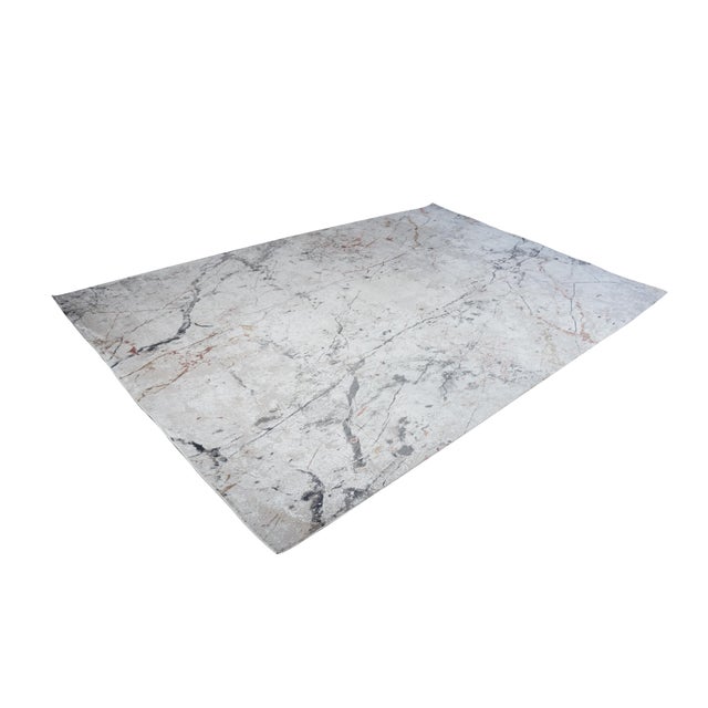 The Haute Couture Collection area rug, measuring 6'6" x 9'6", presents a sophisticated, modern aesthetic inspired by the...