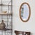 Beautiful vintage rattan mirror from France, 1960s. Oval stacked rattan frame encompassing mirror. Original rattans show...