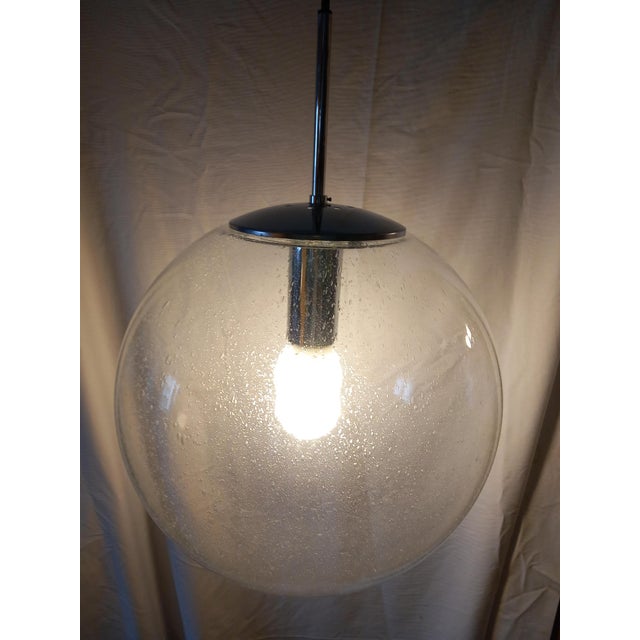 One of three large blown glass sphere pendants, made in Limburg, Germany, circa 1970-1979. Socket: One standard E27 bulb....