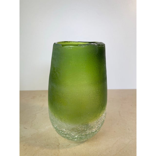 Striking handblown glass vase in a rich olive-to-emerald green ombre, transitioning from a smooth glossy rim down through...