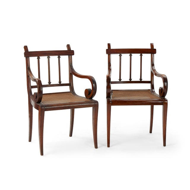 This elegant vintage armchair crafted in warm cherry wood, featuring graceful scrolled arms, distinctive arrow-form back...