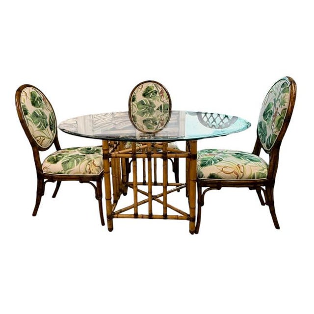 Beautiful vintage bamboo dining set featuring a sculptural base with classic leather-wrapped joints and a 54" beveled...