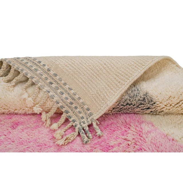 Soft rectangular blocks of blush pink and cool gray sit side by side on a warm ivory field, with faint pastel striping...