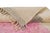 Soft rectangular blocks of blush pink and cool gray sit side by side on a warm ivory field, with faint pastel striping...