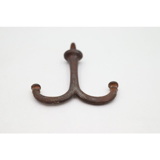 Vintage ceiling mount double arm hook made of cast iron with a black finish and screw top. Good condition with surface...