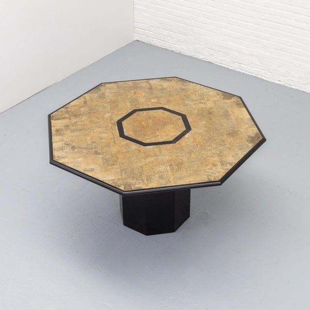 Octagonal Italian dining table dating from the late 1970s to early 1980s, executed in black-stained wood and natural cork....