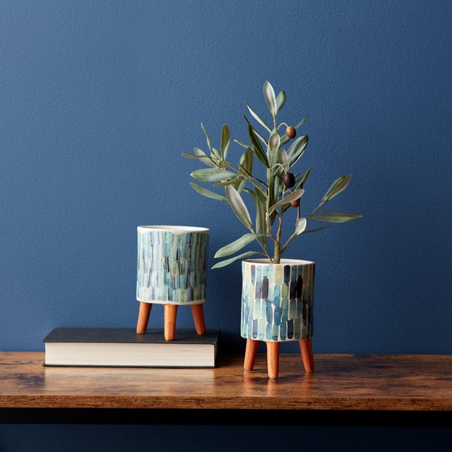 Add a touch of artistic elegance to your space with this chic set of Watercolor Planters. Featuring abstract designs in...