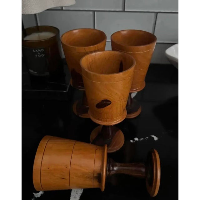 A rare and sculptural set of four hand-turned mid-century goblets, crafted from contrasting hardwoods — likely walnut and...