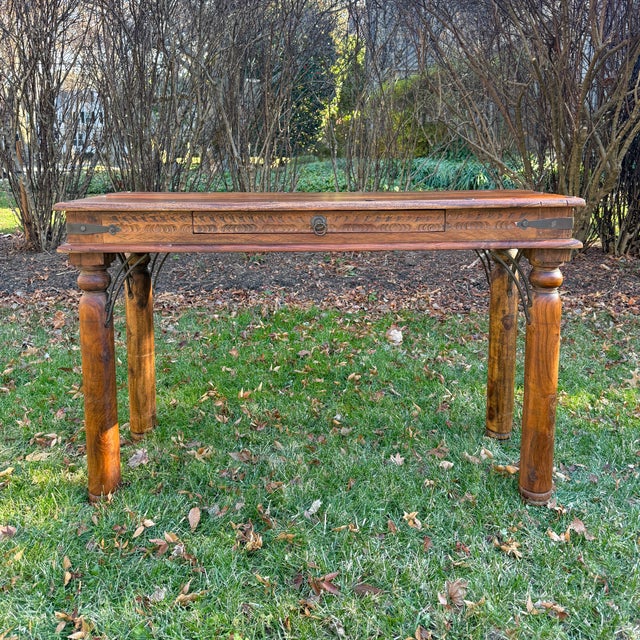 Beautiful vintage Indian carved wooden console table made for Storehouse Furniture. The table features ornate carving to...