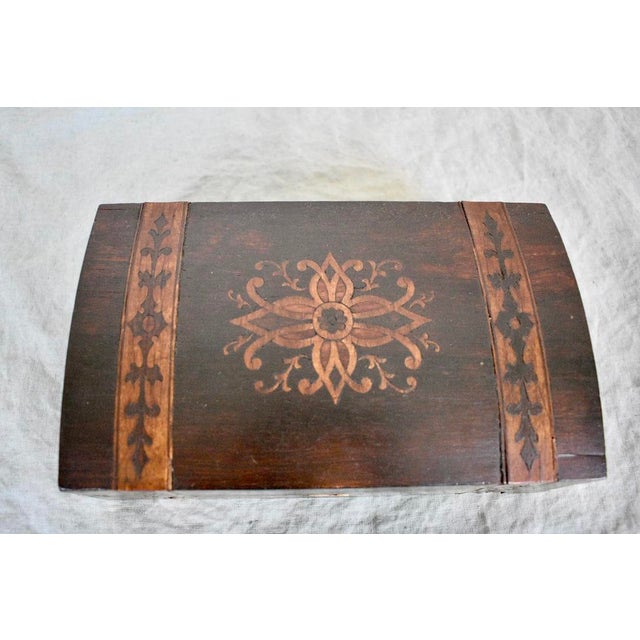 Antique wooden box with contrast inlay design and slightly domed lid. Has developed a beautiful patina over time. There is...