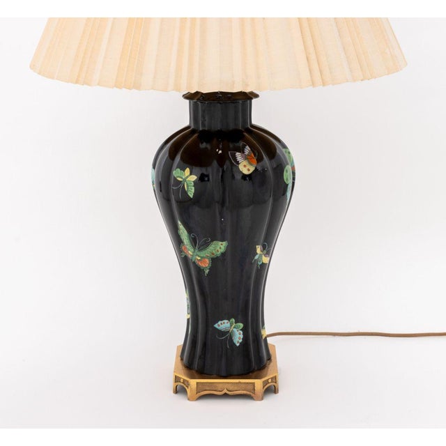 Chinese Famille Noir Porcelain Vase Mounted as a Table Lamp, the reeded meiping with polychrome butterfly motif and...