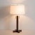 The Swiss Cross table lamp's dark Walnut wood finish creates a statuesque piece of timeless elegance and mid-century...