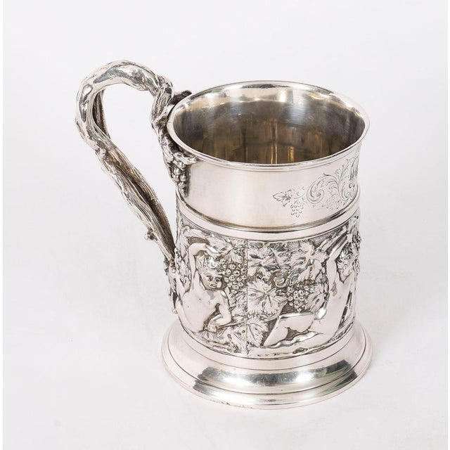 This is a delightful antique early Victorian English silver plated engraved and embossed mug bearing the makers mark of G....