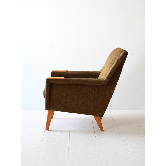 Vintage Scandinavian armchair of Swedish origin. The seat, which includes the armrests, is lined with original period...