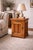 Solid oak icebox-style nightstand featuring a functional swivel top, aged brass hardware, and original White Cap plaque —...