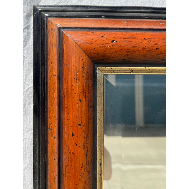 Striking oversized full-length mirror with a richly distressed, warm amber-brown wood frame, abundant natural-looking...