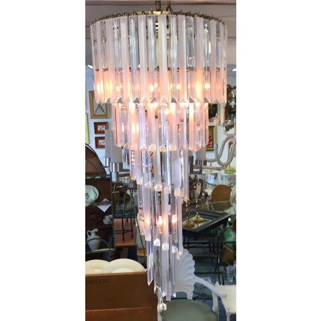 Beautiful Italian style spiraled Lucite chandelier from the mid 20th century. The piece is made of Lucite prisms that hang...